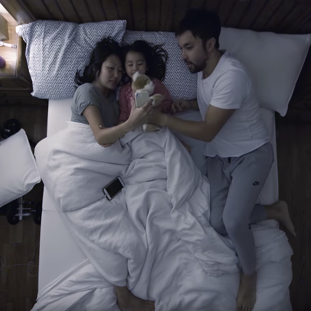 Husband, wife, and daughter in bed