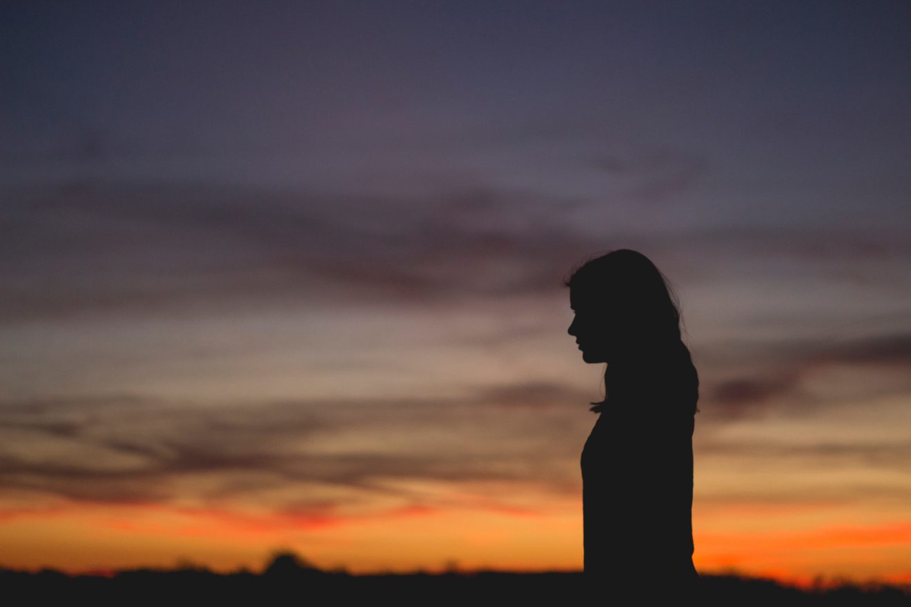 silhouette of a woman with sunrise