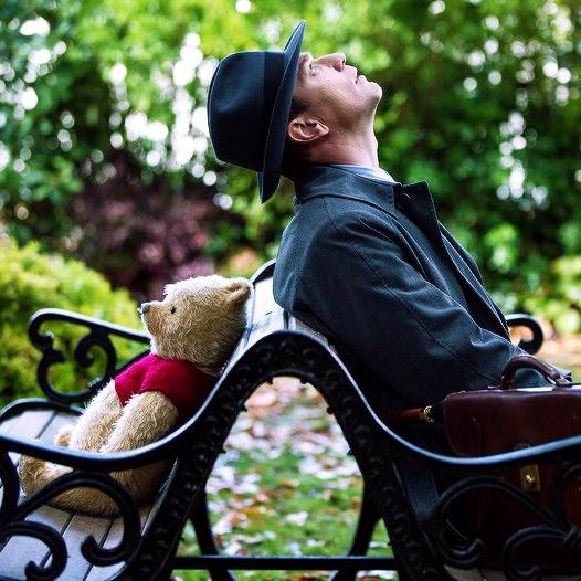 Christopher Robin and Pooh sitting on a bench