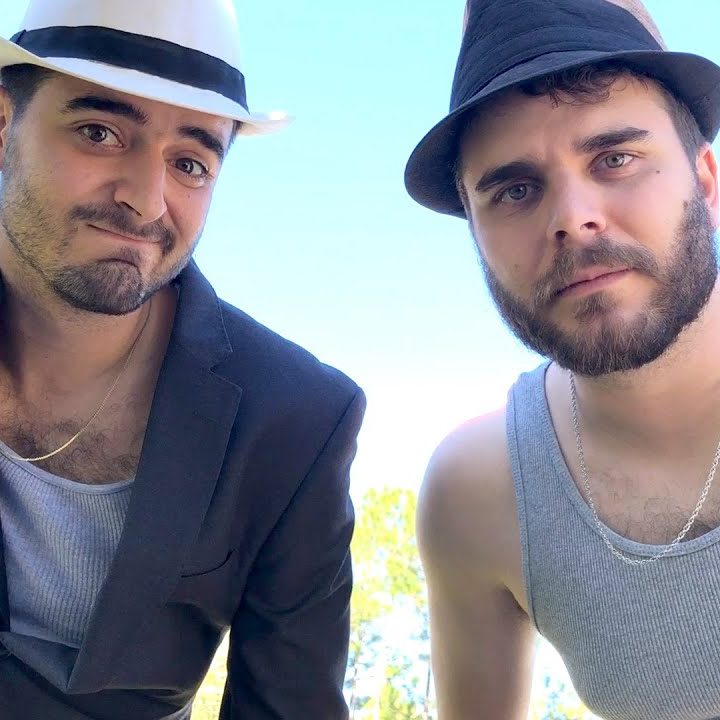 two men wearing fedoras