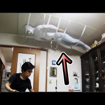 white suited ninja on ceiling